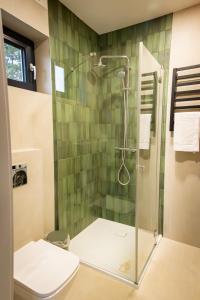 a bathroom with a glass shower with a toilet at Stodoły Pod Gajem z Balią i Sauną in Trzebniów +68 photos