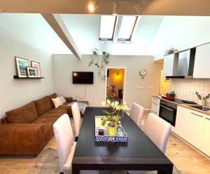 a living room with a table and a couch at Gästeapartment Schkeuditz in Schkeuditz +16 photos