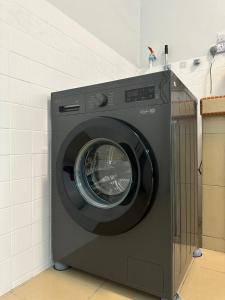 a washing machine is sitting in a room at Sweet Heart Homestay Ujong Pasir Melaka in Melaka