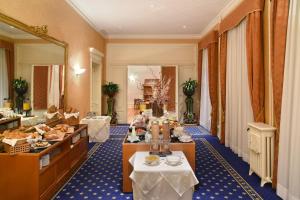 a buffet line in a hotel room with food at Golf Hotel René Capt in Montreux