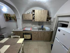 a kitchen with a sink and a counter top at La casa sotto il castello! in Carovigno
