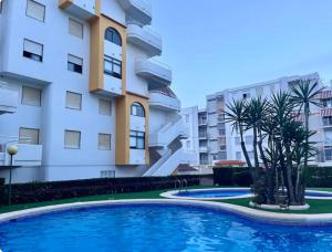 a swimming pool in front of a building at Lugar junto al mar in Casas Las Basas