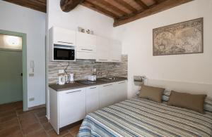 a bedroom with a bed and a sink in a room at The Optimist's House in Staggia