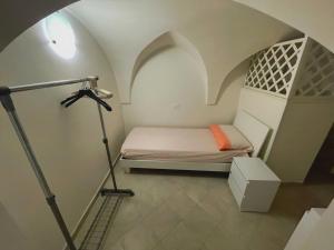 a bedroom with a bed and a tripod in a room at La casa sotto il castello! in Carovigno +5 photos