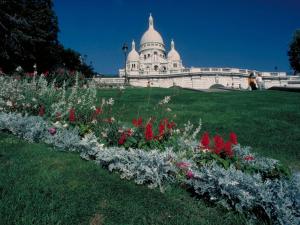 a building with a bunch of flowers in front of it at ibis Paris Montmartre Sacré-Coeur in Paris