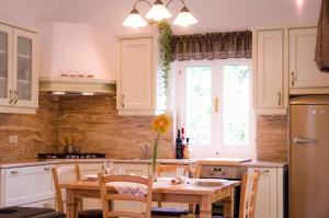 a kitchen with a wooden table with a vase on it at Apartments Beni in Matulji