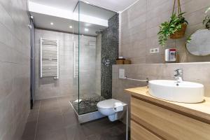 a bathroom with a shower and a toilet and a sink at CASA ROSALIE VI4442 By Riviera Holiday Homes in Villefranche-sur-Mer