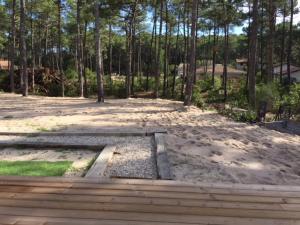 a sandbox in the sand with trees in the background at Villa MA&VA in Lacanau-Océan