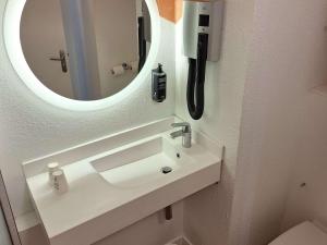 a bathroom with a white sink and a mirror at ibis Styles Toulon Centre Port in Toulon
