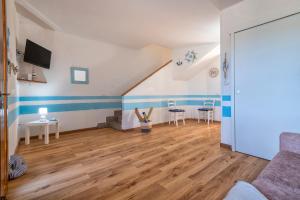 a living room with blue and white stripes on the walls at Holiday Cala Sant'andrea in Stintino