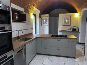 a kitchen with a sink and a counter top at Lovely 6 bed Tuscan Farmhouse in Villamagna