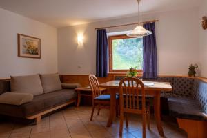 a living room with a couch and a table at Planitzhof in Castelrotto