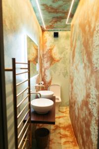 a bathroom with a sink and a toilet in it at Town Centre Apartments with Spa in Morpeth +35 photos