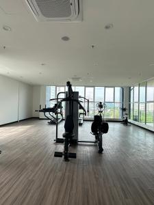 a gym with cardio equipment in a large room with windows at ICC Luxury Suites Ipoh City Centre By Landmark in Ipoh