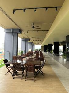 a cafeteria with wooden tables and chairs in a building at ICC Luxury Suites Ipoh City Centre By Landmark in Ipoh