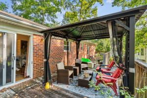 a pergola with chairs and tables on a patio at Charming Family Retreat with Scenic Views home in Flat Run +19 photos