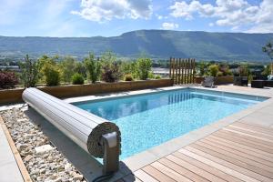 una piscina con panchina accanto a una terrazza in legno di Studio voûté, atypique a Chambéry