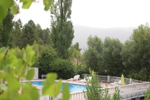 una piscina con árboles y una valla blanca en Chorros del Río Mundo en Riópar