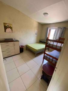 a small room with a bed and a bunk bed and a room with at Chácara para final de semana em família in Sorocaba