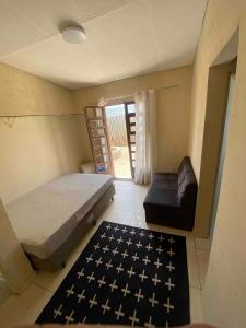 a bedroom with a bed and a couch in it at Chácara para final de semana em família in Sorocaba
