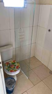 a bathroom with a toilet and a glass shower at Chácara para final de semana em família in Sorocaba +20 photos