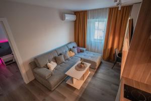 a living room with a couch and a table at Lotus 1 in Ploieşti