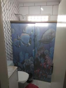 a bathroom with an ocean themed shower stall with fish at Beautiful house in the campoline the best neighborhood of sorocaba in Sorocaba