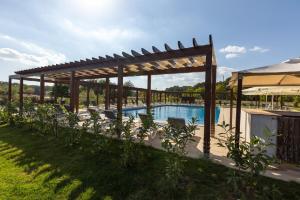 a wooden pergola next to a swimming pool at Casa Vlasia in Snagov +40 photos