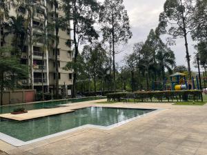 a swimming pool in a park with a playground at NR Cyber1 Homestay in Cyberjaya