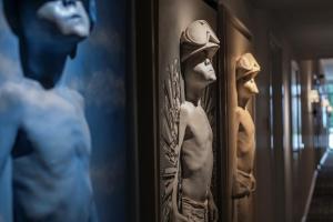 a couple of statues of men in a room at The Donna Portals in Portals Nous