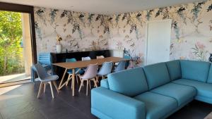 a living room with a couch and a table and chairs at Casa con piscina Sanxenxo in Pontevedra