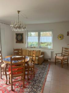 a living room with a table and chairs and a couch at Nicoles Niedschlösschen in Rehlingen-Siersburg