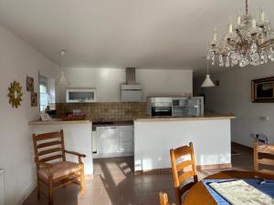 a kitchen with a table and two chairs and a counter at Nicoles Niedschlösschen in Rehlingen-Siersburg