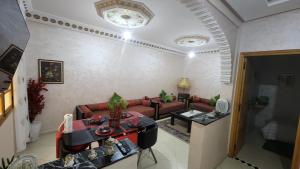 a living room with a couch and a table at Appartement B à 7min de l’aéroport de Marrakech in Marrakech