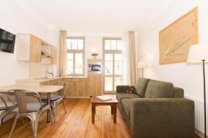 a living room with a couch and a table at 6 Windspiel in Rostock +7 photos