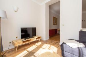 a living room with a tv and a couch at 3 Wellenzauber in Rostock