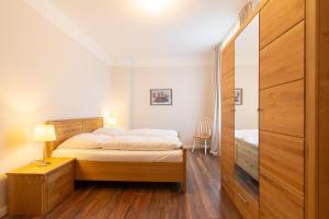 a bedroom with a bed with a wooden headboard at 5 Meereslust in Rostock