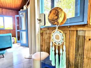 a room with a wooden wall with a basket on the wall at Cabana Aruá in Praia do Rosa