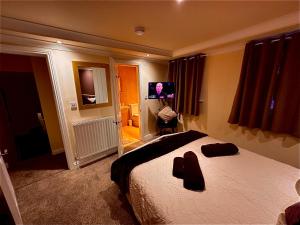 a bedroom with a bed and a tv in it at Church View Richmond - spacious, 2 bed ensuite luxury apartment in town centre in Richmond