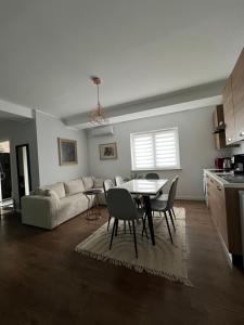 a living room with a couch and a table and chairs at Apartament B&B Cajvana in Cajvana +13 photos