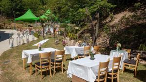 a group of tables with white tablecloths and chairs at Ganghwado Baba Valley Pension in Incheon