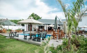 a patio with tables and chairs and a pool at 10 on Pauling Hotel Bulawayo in Bulawayo