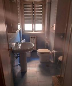 a bathroom with a sink and a toilet at Intero appartamento Marconi in Rome
