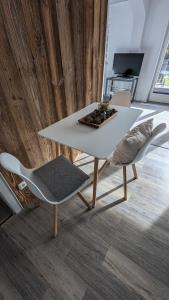 einen weißen Tisch und Stühle in einem Zimmer in der Unterkunft Garten 2-Zimmer WHG in Bestlage in Rottach-Egern, 400m vom See in Rottach-Egern