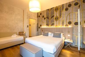 A bed or beds in a room at UNAHOTELS Imperial Sport Hotel