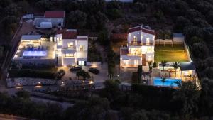 an aerial view of a mansion at night at Montis villa sea view heated pool in Daratso