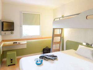 Postel nebo postele na pokoji v ubytování ibis budget Noyon