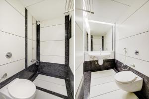 a bathroom with a toilet and a sink at Collection O Riddhi Siddhi in Vadodara