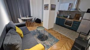 a living room with a couch and a table and a kitchen at SKP-091 a&b in Skopje