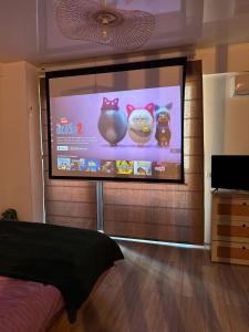a projection screen with three cats on it in a room at The ideal place by the sea Mamaia Nord Lidl area in Mamaia Nord